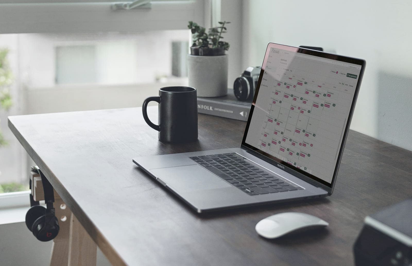 The Movari appointment book open on a laptop on a practitioner's desk
